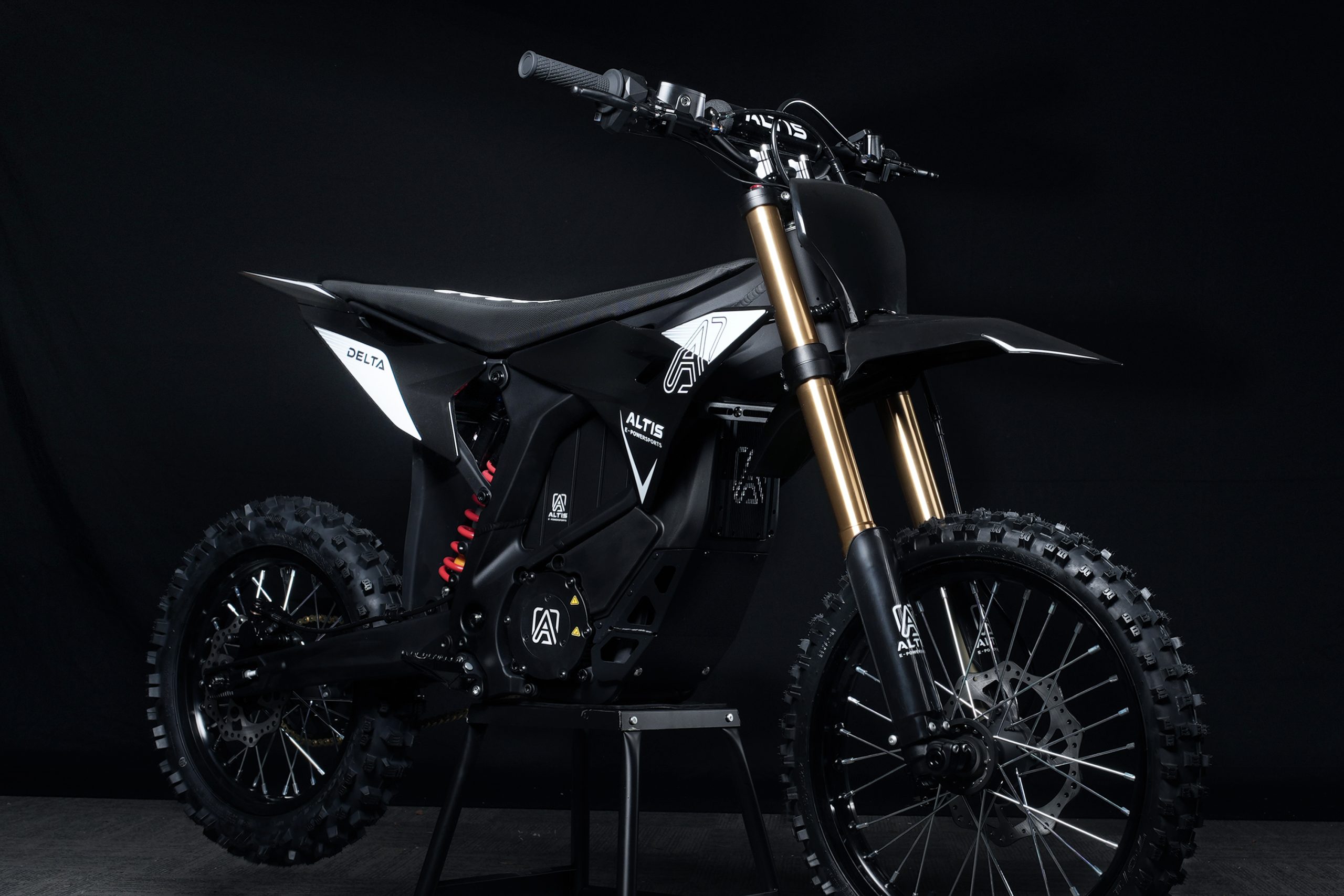Altis Delta high performance electric dirt bike full side view in black and white with gold suspension forks